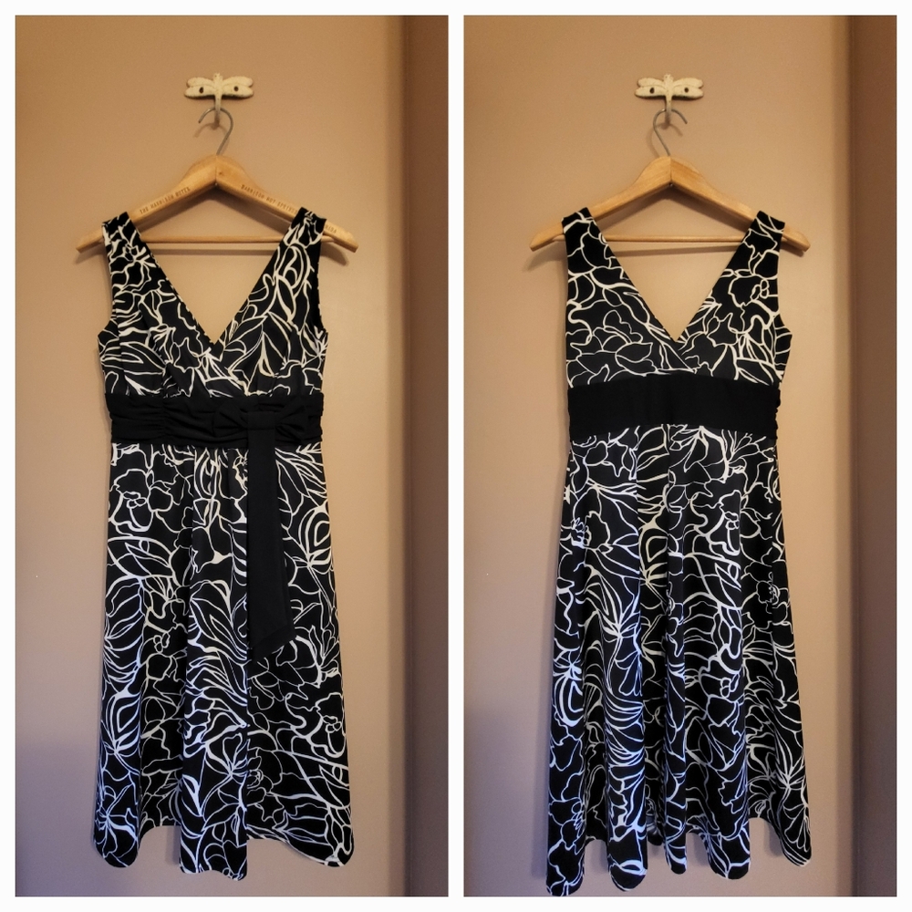 Black & white sleeveless floral dress with attached sash and bow. Size 4